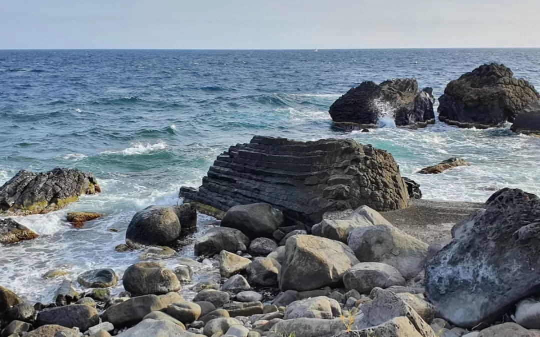 Rock beach with lava basalt columns